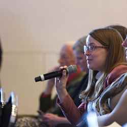 An audience member asks a question of the panel