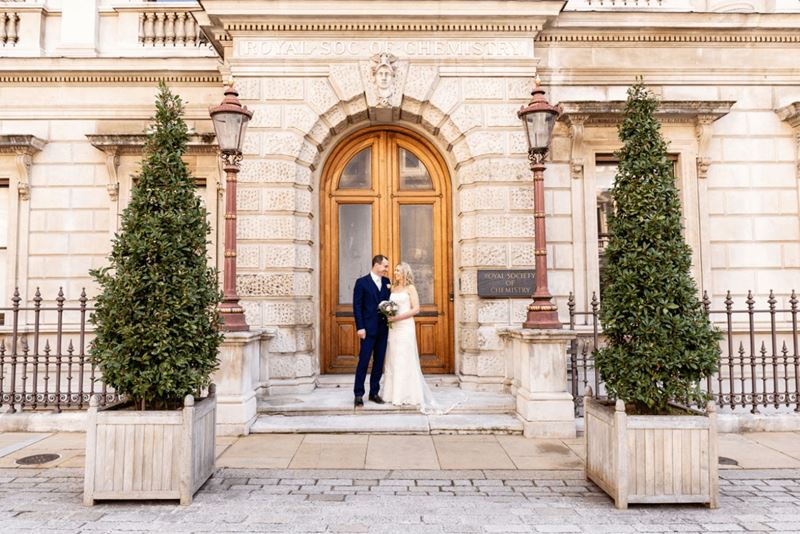 Newly married couple standing outside Burlington House